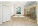 Main bathroom featuring a bathtub, shower, tile floors, and a large window at 3134 Hudson Pond Ln, Marietta, GA 30062