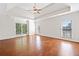A spacious main bedroom with hardwood floors, a ceiling fan, recessed lights, and large windows at 3134 Hudson Pond Ln, Marietta, GA 30062