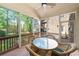Screened in back porch featuring a ceiling fan, wood floors, and a table with chairs at 3134 Hudson Pond Ln, Marietta, GA 30062
