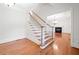Staircase with hardwood treads, white risers, and access to a living room with fireplace at 3134 Hudson Pond Ln, Marietta, GA 30062