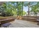Relaxing back deck with wooden benches surrounded by mature trees, great for entertaining at 3298 Robinson Oaks Ne Way, Marietta, GA 30062