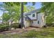 Backyard view of home with deck, and shaded yard with mature trees, promoting peaceful outdoor living at 3298 Robinson Oaks Ne Way, Marietta, GA 30062