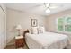Cozy bedroom featuring a ceiling fan, and a side table with lamps at 3298 Robinson Oaks Ne Way, Marietta, GA 30062