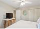 Well-lit bedroom with ceiling fan, TV and closet with bi-fold doors at 3298 Robinson Oaks Ne Way, Marietta, GA 30062
