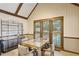 Inviting dining area with exposed beam ceiling, wooden framed windows, and a stylish shelving unit at 3298 Robinson Oaks Ne Way, Marietta, GA 30062