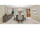 Elegant dining room with a table, upholstered chairs, sideboard, and decorative lighting at 3298 Robinson Oaks Ne Way, Marietta, GA 30062