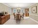Inviting dining room with elegant chandelier, decorative walls, and seamless access to adjacent kitchen at 3298 Robinson Oaks Ne Way, Marietta, GA 30062