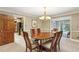 Well-lit dining room showcasing a wood table, chandelier, and access to other rooms at 3298 Robinson Oaks Ne Way, Marietta, GA 30062