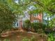 Well-maintained two-story brick home with lush landscaping, mature trees, and a charming entrance at 3298 Robinson Oaks Ne Way, Marietta, GA 30062