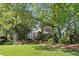Beautiful two-story brick home nestled among lush trees with a well-manicured lawn at 3298 Robinson Oaks Ne Way, Marietta, GA 30062