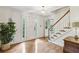 Bright foyer with white door, hardwood floors, and staircase at 3298 Robinson Oaks Ne Way, Marietta, GA 30062