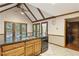 Bright kitchen with wood cabinets, modern appliances, and a vaulted ceiling with beams at 3298 Robinson Oaks Ne Way, Marietta, GA 30062