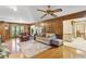 An expansive living room showcases hardwood floors, ceiling fan, and seamlessly connects to other areas at 3298 Robinson Oaks Ne Way, Marietta, GA 30062