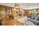 Cozy living room features wood paneling, a fireplace, and hardwood floors at 3298 Robinson Oaks Ne Way, Marietta, GA 30062