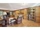 Cozy living room featuring wood paneling, a fireplace, and built-in shelving at 3298 Robinson Oaks Ne Way, Marietta, GA 30062