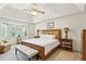 Inviting primary bedroom with tray ceiling, large window, neutral tones and upholstered headboard at 3298 Robinson Oaks Ne Way, Marietta, GA 30062