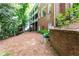 Large backyard features a brick retaining wall and view of multi-level deck at 710 Leeds Garden Ter, Alpharetta, GA 30022