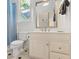 Cozy bathroom with a toilet, sink, and mirror at 710 Leeds Garden Ter, Alpharetta, GA 30022