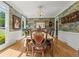 Elegant dining room featuring decorative wallpaper, hardwood floors, and large windows with natural light at 710 Leeds Garden Ter, Alpharetta, GA 30022