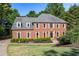 Stately brick home with manicured lawn, mature trees, and tasteful landscaping at 710 Leeds Garden Ter, Alpharetta, GA 30022
