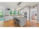 Bright kitchen boasts an island with seating, granite countertops and modern lighting at 710 Leeds Garden Ter, Alpharetta, GA 30022