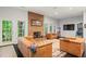 Relaxing living room area with leather sofa, fireplace, and plenty of natural light at 710 Leeds Garden Ter, Alpharetta, GA 30022