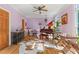Bright living room with a grand piano, hardwood floors, and large windows overlooking the outside at 710 Leeds Garden Ter, Alpharetta, GA 30022