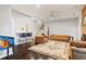 Open-concept living space with hardwood floors, a bar area, and leather furniture at 710 Leeds Garden Ter, Alpharetta, GA 30022