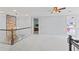 Loft featuring an interior stone column and staircase with carpet at 710 Leeds Garden Ter, Alpharetta, GA 30022