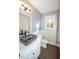 Updated bathroom with dark fixtures, custom sink and wood-look flooring at 7156 Whitfield Dr, Riverdale, GA 30296