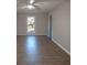 Spacious bedroom with neutral colors, wood-look floors, and a bright window at 7156 Whitfield Dr, Riverdale, GA 30296