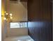 Bright bedroom with hardwood floors, a view to trees through a window and a modern chandelier at 7156 Whitfield Dr, Riverdale, GA 30296