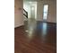 Inviting entryway with hardwood flooring, a diamond-patterned front door, and a staircase at 7156 Whitfield Dr, Riverdale, GA 30296