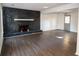 Spacious living room featuring a stone fireplace with hardwood floors at 7156 Whitfield Dr, Riverdale, GA 30296