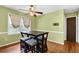 Cozy dining area with hardwood floors, a four-chair table set, and bright light from the kitchen at 1192 Pathfinder Rd, Marietta, GA 30066