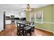 Open dining area with hardwood floors, a four-chair table set, and view of the bright and modern kitchen at 1192 Pathfinder Rd, Marietta, GA 30066