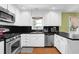 Bright kitchen featuring stainless steel appliances, white cabinets, and dark countertops at 1192 Pathfinder Rd, Marietta, GA 30066