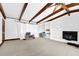 Expansive living room features a brick fireplace, exposed beams, and neutral carpet, creating a cozy space at 1192 Pathfinder Rd, Marietta, GA 30066