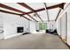 Large living room with exposed beams, a white brick fireplace, and sliding glass doors that let in plenty of light at 1192 Pathfinder Rd, Marietta, GA 30066