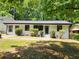 Charming single-story home boasts a freshly painted white exterior, black-trimmed windows, and a well-maintained front yard at 188 Oak Dr, Atlanta, GA 30354