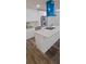 Modern kitchen featuring an island with stone countertops, stainless steel appliances, and a distinctive blue range hood at 188 Oak Dr, Atlanta, GA 30354