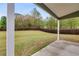 Back patio features an expansive backyard with green grass and a tall privacy fence at 209 Shelton Cir, Temple, GA 30179