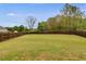 A large, fully-fenced backyard with lush green grass, perfect for outdoor activities and privacy at 209 Shelton Cir, Temple, GA 30179
