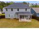 Home's backyard features well-maintained lawn, covered patio, and full privacy fence at 209 Shelton Cir, Temple, GA 30179