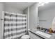 Clean bathroom featuring a shower with curtain, modern vanity and mirror, and neutral colors at 209 Shelton Cir, Temple, GA 30179