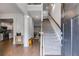 Welcoming foyer with hardwood floors, staircase, and a glimpse into the kitchen and living areas at 209 Shelton Cir, Temple, GA 30179