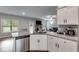Open kitchen layout with granite countertops, stainless steel dishwasher, and views into the living area with fireplace at 209 Shelton Cir, Temple, GA 30179