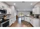 Modern kitchen design showcasing white cabinets, stainless steel appliances, and hardwood flooring throughout the space at 209 Shelton Cir, Temple, GA 30179