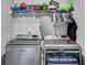 Convenient laundry room with modern machines, storage shelf, and space for ironing at 209 Shelton Cir, Temple, GA 30179
