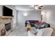 Bright living room featuring a stone fireplace, plush carpet, and lots of natural light at 209 Shelton Cir, Temple, GA 30179